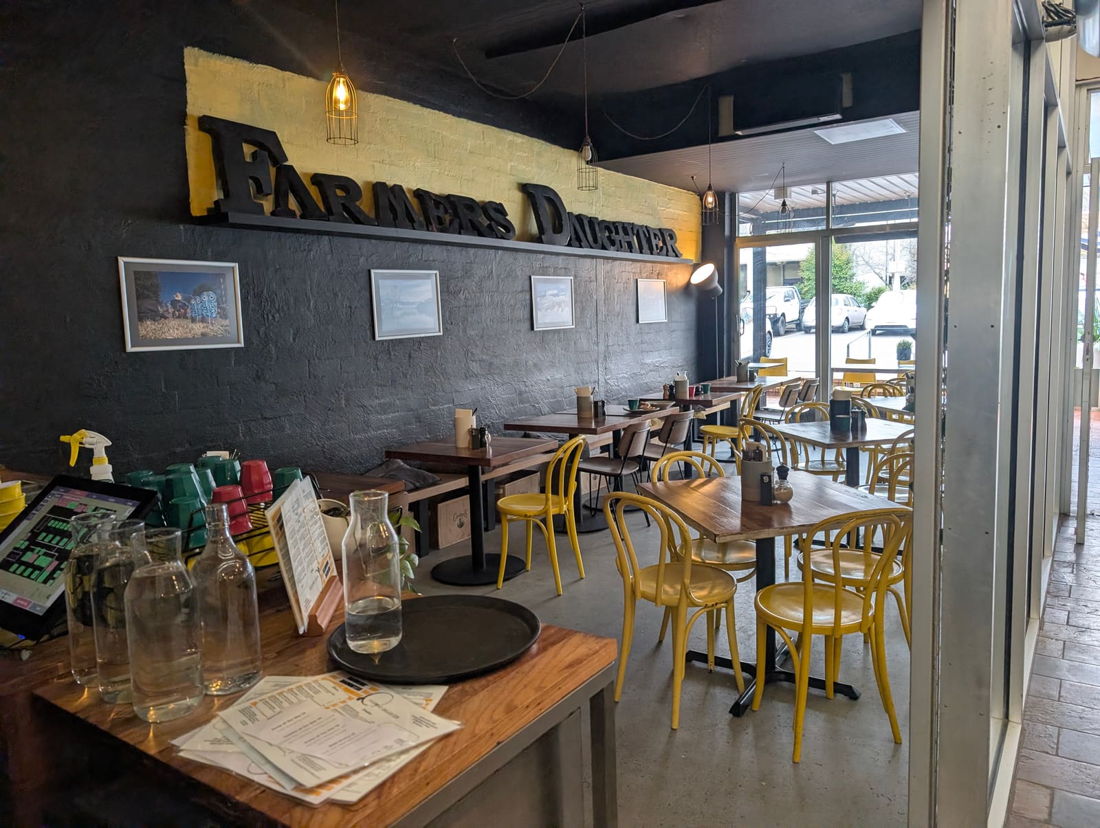 The Farmers Daughter dining room with its bold signage and yellow bentwood chairs